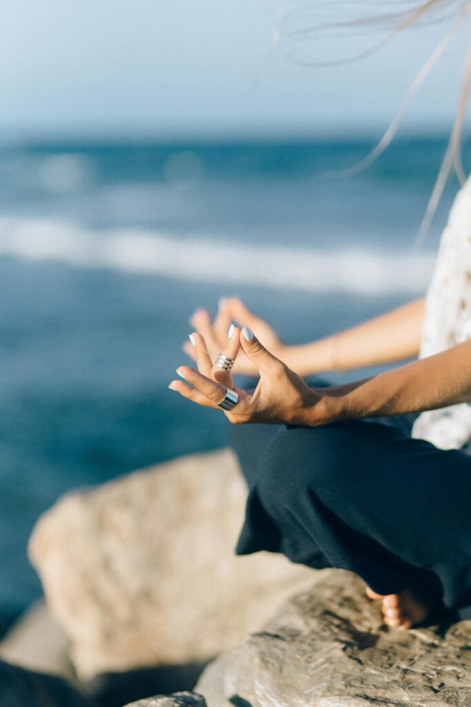 pexels-photo-5201522-5201522 Close-up of a person meditating by the seaside, capturing tranquility and balance.